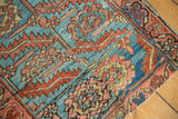 Heriz fragment: serrated leaves, floral designs, sky blue, madder red, blush, visible seam.