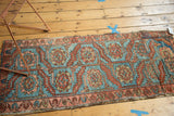 Professionally seamed antique Heriz rug fragment displaying sky blue and terracotta geometric patterns.