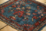 Textured hand-knotted Lilihan rug pile, displaying cranberry red floral palmettes on an indigo field.