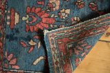 Vintage Lilihan rug corner showing foundation weave, indigo pile, and tattered side.