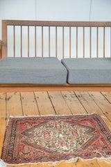 Antique Bag Face rug showing paisley boteh motif, aged pile, and tattered fringe.