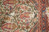 Ivory field of antique Persian Bag Face rug with paisley boteh, arabesques, and foundation.