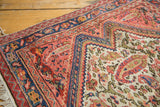 Antique Persian Bag Face rug corner: ivory field, delicate paisley boteh, intricate stepped border.