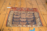 Antique Kurdish rug with serrated leaf motif, red borders, and pronounced central wear.