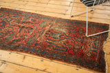 Worn vintage Lilihan fragment with raspberry red field, blue border, and tattered end.