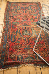 Tattered fringe, blue border, and intricate Gerus inspired arabesques on this Lilihan rug fragment.