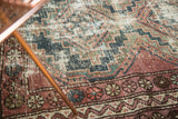 Close-up of vintage Hamadan rug border with raspberry red floral cross sections and foundation wear.