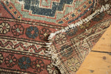 Vintage Hamadan rug corner showing hard tatter to fringe and colorful hand-knotted back.