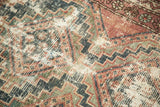 Visible foundation and worn geometric zigzags in indigo, faded red, and sage green.