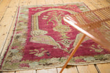 Angled view of an antique Armenian Karabagh rug styled in a room, highlighting its character.