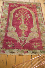 The storied patina of an antique Karabagh prayer rug showing its tree-of-life design in blush and earth tones.