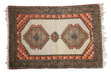 Vintage Ardebil hand-knotted rug with ivory field, geometric medallions, and apricot bird motifs.