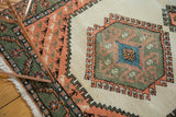 Vintage Ardebil rug's apricot corner spandrel with repeating bird motif, sage green border.