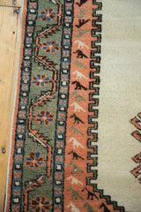 Apricot border with repeating bird motifs, sage green floral band, and ivory field.