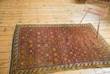 Antique Karabagh rug's unique barber pole border and allover dusty mauve boteh motif.