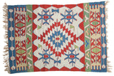 Vintage Turkish Kilim rug with diamond, crab, and vine motifs in red, ivory, blue, saffron, green.