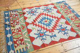 End finish of vintage Kilim rug with meandering vine borders and serrated diamonds.
