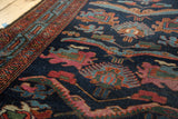 Vintage Persian Mehreban runner's asymmetric reptile motifs in indigo, madder red, and mallard green.