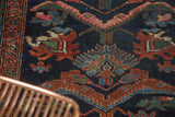 Detailed view of hand-knotted Mehreban rug's intricate finned floral blossoms and border pattern.