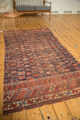 Antique Afshar rug border with tribal geometric motifs in madder red and sky blue.
