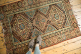 Stepped diamond contours, wave border, and tattered ends on this vintage Hamadan rug.