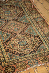 Hard tatter and reciprocating wave border of vintage Hamadan rug, apricot and blue tones.