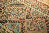 Stepped diamond, hook, and wave motifs of a Hamadan rug in apricot, brown, and sky blue.