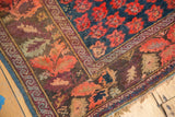 Corner of an antique Armenian Karabagh carpet, indigo blue with red floral trellis, aubergine and celadon borders.