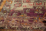 Antique Caucasian rug: textured wear, exposed foundation, and aubergine tangerine geometric vinery.
