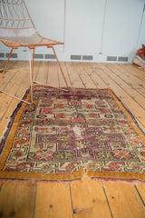 Antique Caucasian rug corner with frayed fringe and visible foundation wear.