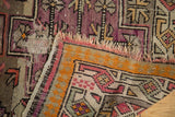 Antique Caucasian rug with exposed foundation, tattered fringe, and geometric motifs.