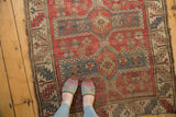 Vintage Caucasian Avar style rug featuring red field, blue elongated medallions, and serrated leaf border.