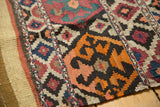 Geometric diamonds and tangerine orange crab motifs with plain weave banding on an antique Shahsavan Kilim.