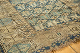 Geometric motifs, foundation wear, and tattered end on this antique Caucasian rug.