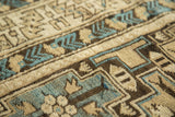 Hand-knotted pile with geometric stepped patterns in sky blue, ivory, and charcoal brown.