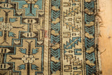Edge of antique Caucasian rug, circa 1910s, showing hard tatter and repair.