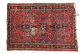Vintage Persian Dargezine rug with rich red field, oversized herati leaves, and indigo accents.