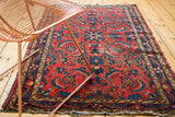 Vintage Dargezine rug detail: red field, indigo pinwheel leaf border, and soft wear.