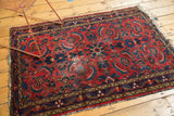 Vintage Dargezine rug showing fringed end, pinwheel leaf main border, and field wear.
