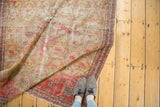 Distressed antique Zuli Sultan rug, saffron gold field with red floral bouquets and visible wear.