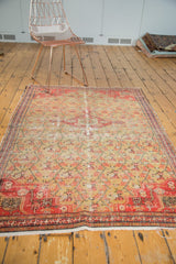 Antique Zuli Sultan rug bottom corner, bright red border, saffron floral lattice, tattered edge.