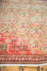 Worn antique Zuli Sultan rug: tattered fringe, red border, saffron floral lattice.