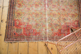 Aged saffron field, red border, and frayed edges of an antique Zuli Sultan rug.