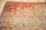 Antique Zuli Sultan rug's saffron gold chained lattice field with blossomed red florals, revealing storied wear.