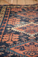 Vintage Baktiari rug detail, showing navy and terra cotta Mahi pattern with visible wear.