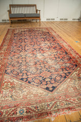 Vintage Malayer runner, tattered end fringe, meandering vine border, and madder red Herati motifs.