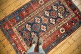Storied antique Kurdish rug fragment, Mina Khani floral field, arabesque border, indigo and red.