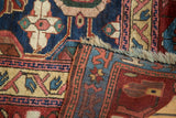 Fold of antique Kurdish rug fragment showing indigo Mina Khani design, visible foundation, and fringe.