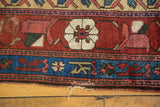 Aged lower edge of the antique Kurdish fragment, highlighting indigo border and Mina Khani floral.