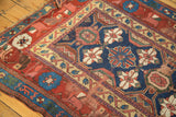 Mina Khani floral design and primitive border of antique Kurdish fragment in indigo, red, beige.